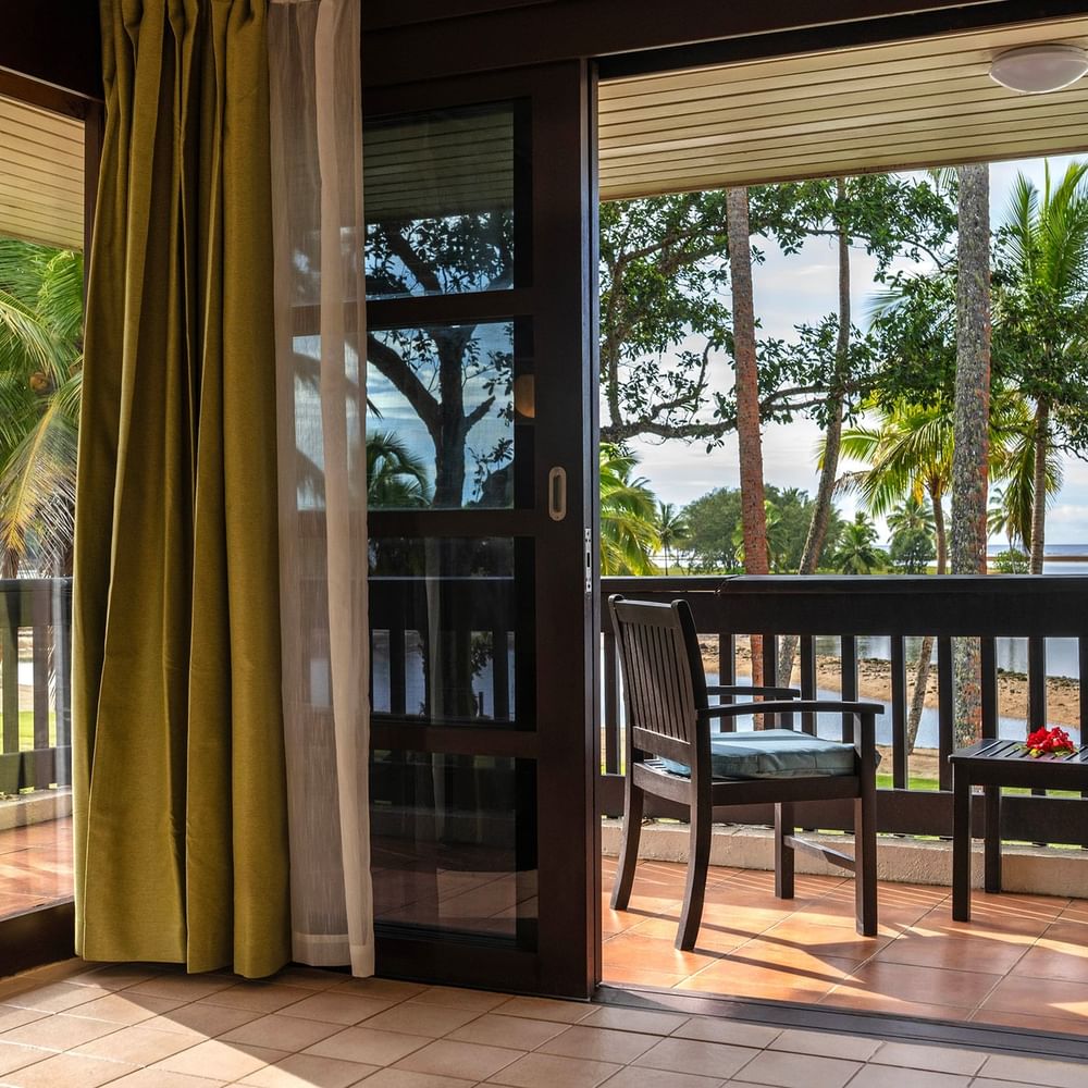 Balcony with chairs and ocean view at The Naviti Resort in Korolevu.