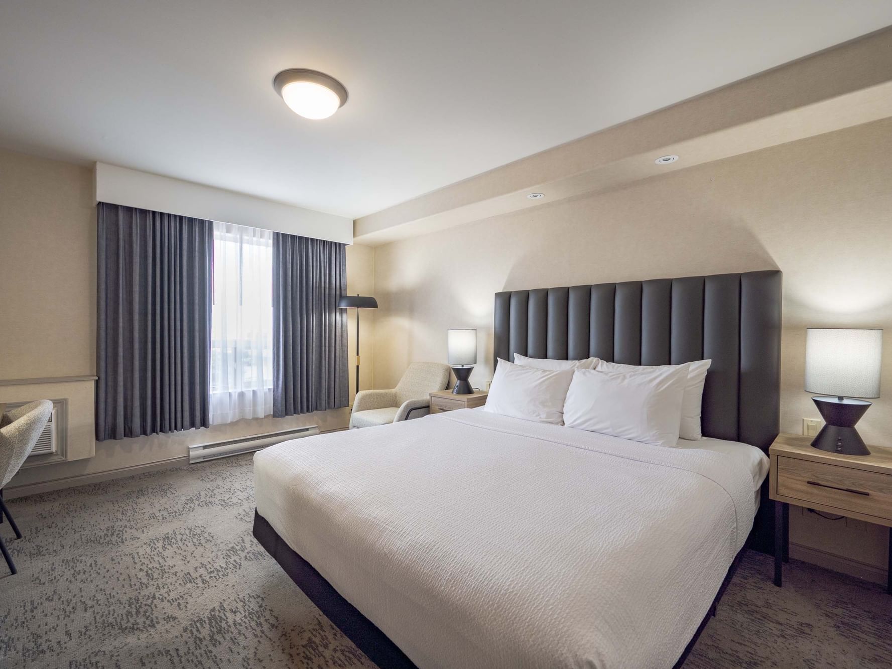 Bed with nightstands in Standard Room, hotel rooms in Winnipeg MB at Sandman Hotel & Suites Winnipeg Airport