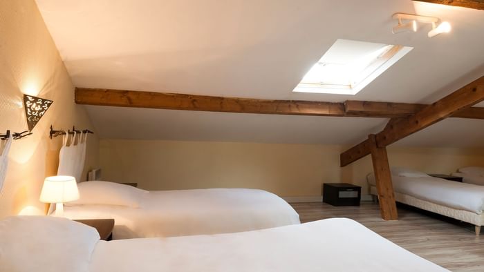 Twin Beds in a room at Hotel Le Cheval Rouge