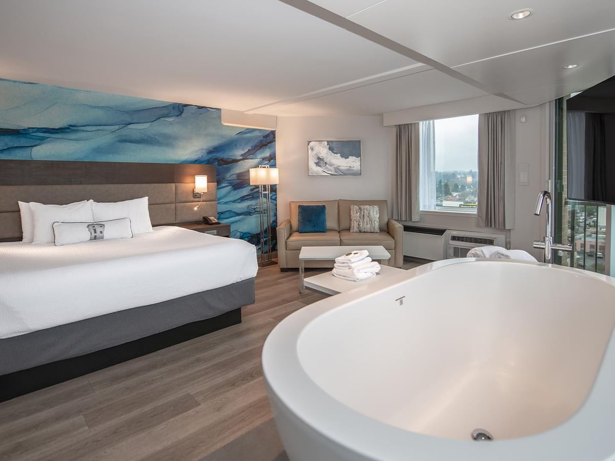 King bed and freestanding tub in Coast Premium King Suite at Coast Bastion Hotel in Nanaimo.