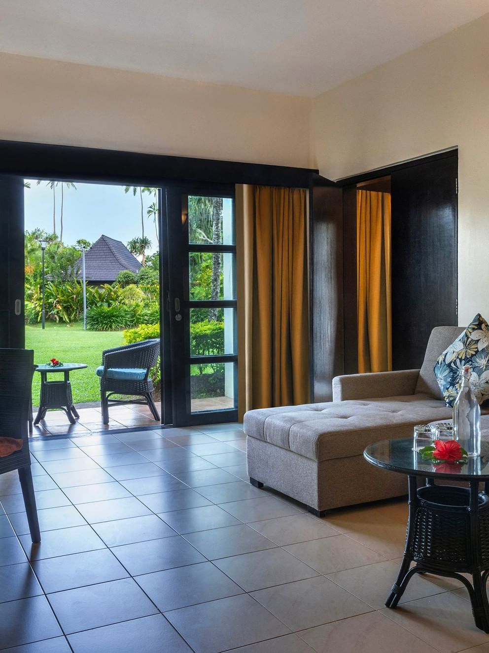 Living area of a suite with garden view at The Naviti Resort in Korolevu.