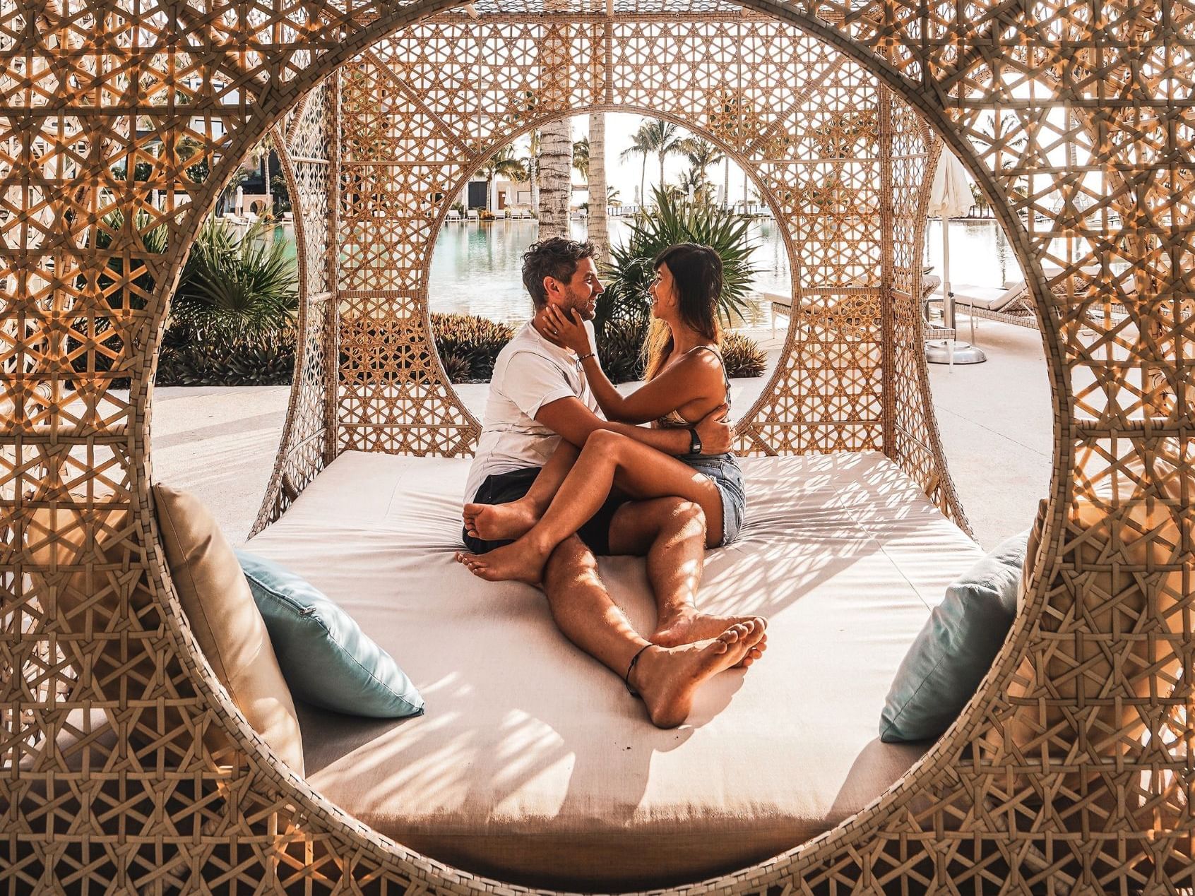 A couple relaxing on a bed outdoors at Haven Riviera Cancun