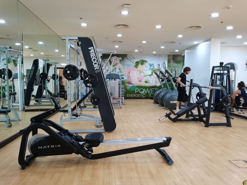 A man exercising in the gym at Two Seasons Hotel & Apt