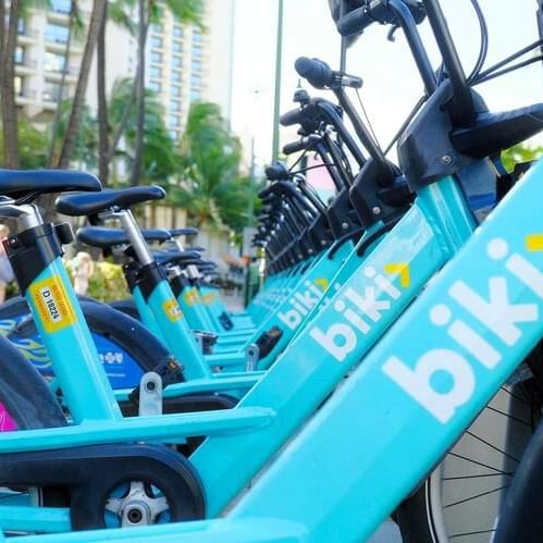 Close-up of Biki bikes parked outside the hotel at Waikiki Resort Hotel by Sono