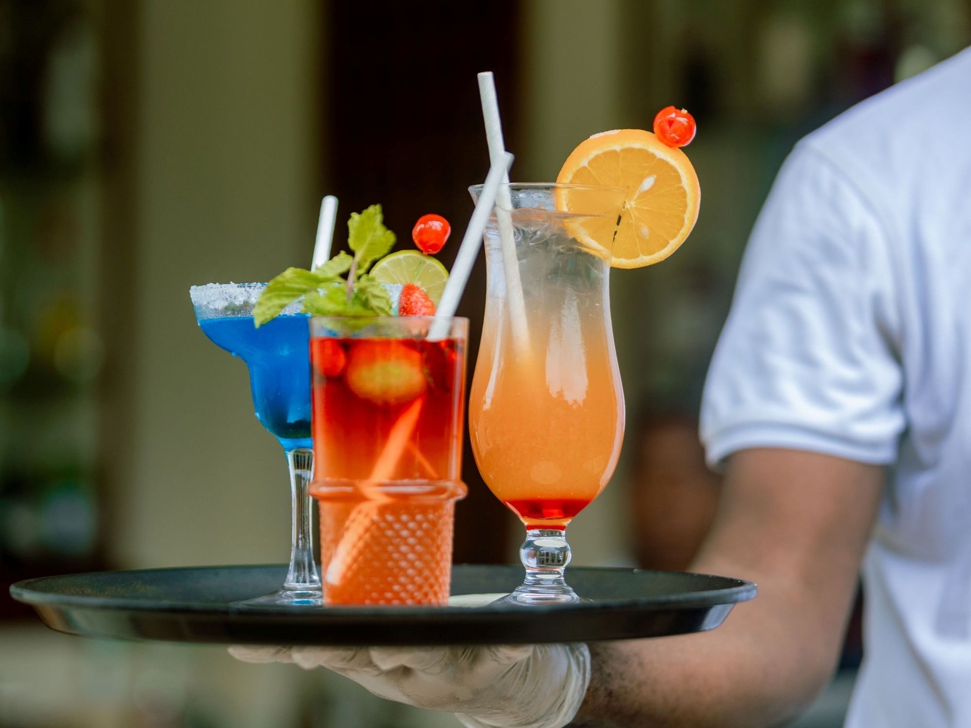 Tray with three colorful drinks at Kibo Bar and Terrace in Dar es Salaam at Dar Es Salaam Serena Hotel.