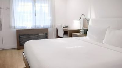 Bed & working desk in a room at The Nest Palo Alto