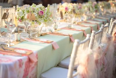 Dining table at The Saujana Hotel Kuala Lumpur, set with floral centerpieces, glassware, and soft pastel linens