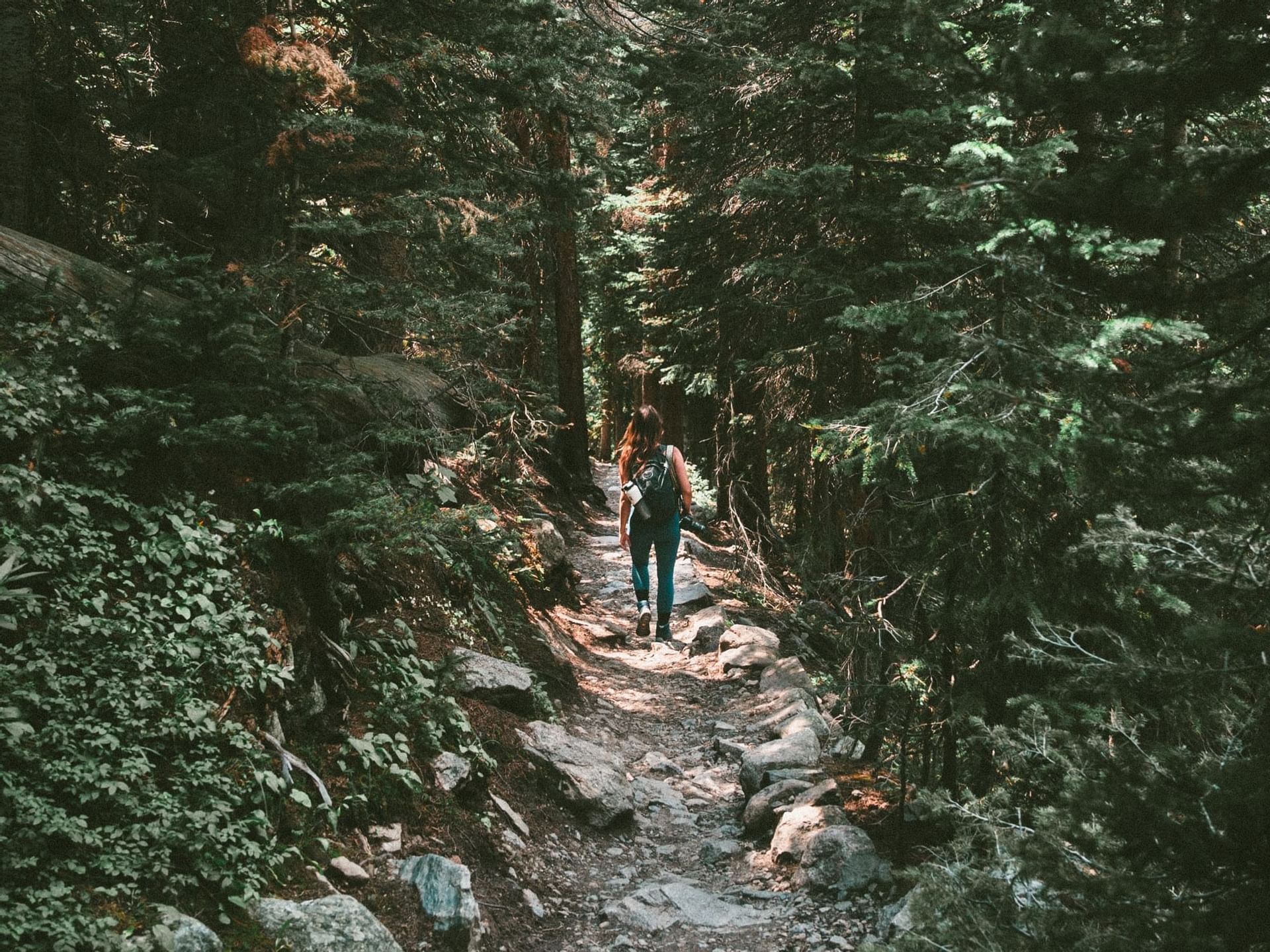 Woman hiking in the mountains near Kinship Landing
