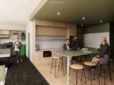 People in a modern office with desks, stools, a kitchen area, and shelves at UniLodge Brisbane City.