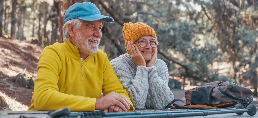 Two people admire the view at a lookout point on a trail in Canmore.