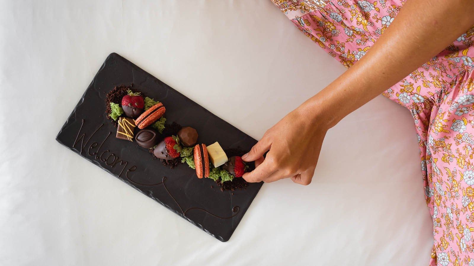 Sweet dessert with Macarons served on a bed at Pullman Cairns