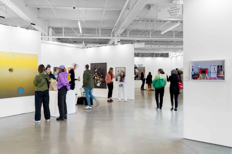 Visitors viewing contemporary art in a bright gallery space near Warwick Le Crystal Montreal