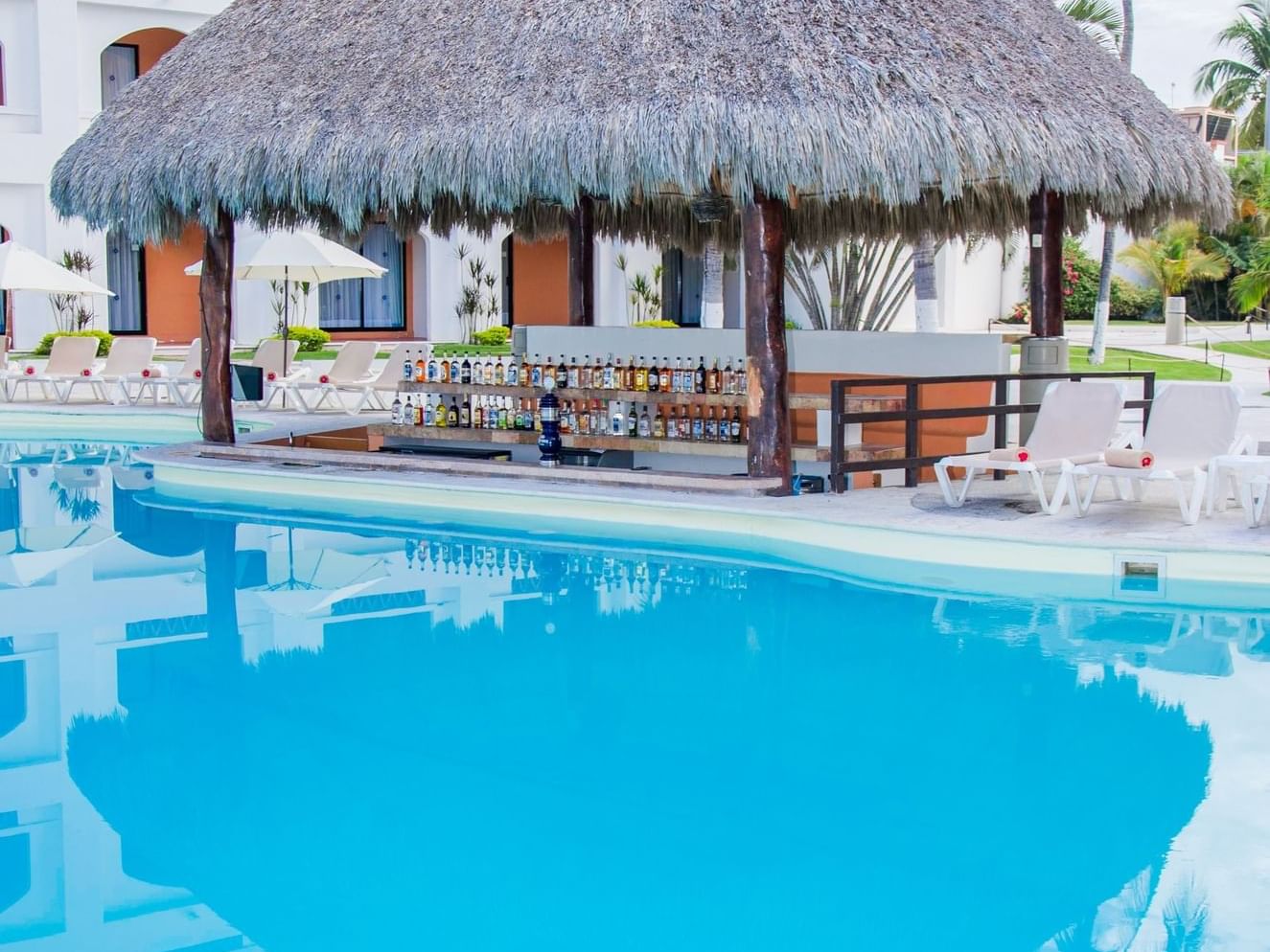 Outside pool area with sunbeds and bar area in Gaviotas Aqua Bar at Plaza Pelicanos Club Beach Resort