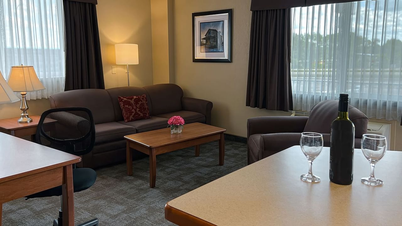 Living area of hotel suite with sofa, chair, table, coffee table