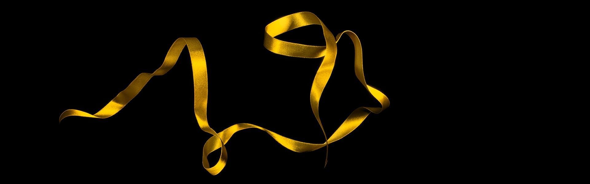 Black background image with a yellow ribbon at Crown Tower