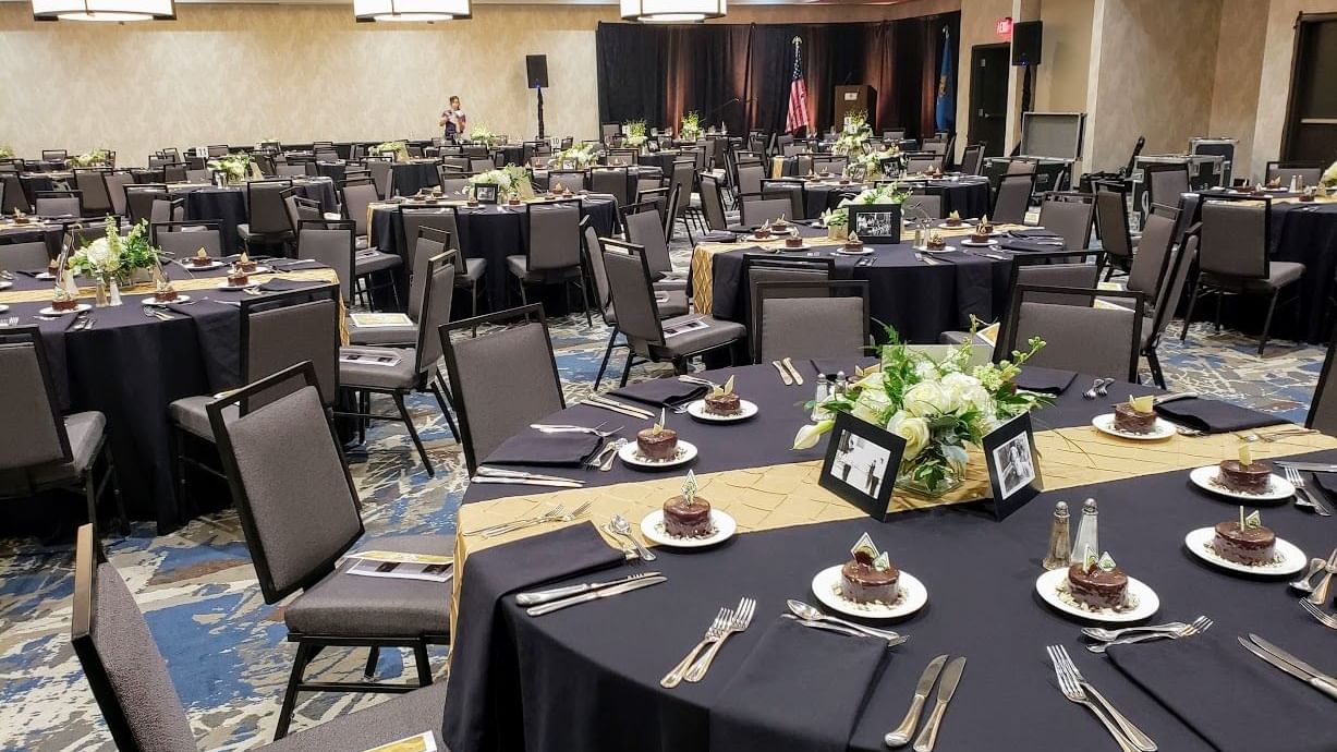 Roosevelt Ballroom at Shangri-La Monkey Island set for an event, with round tables covered in black tablecloths
