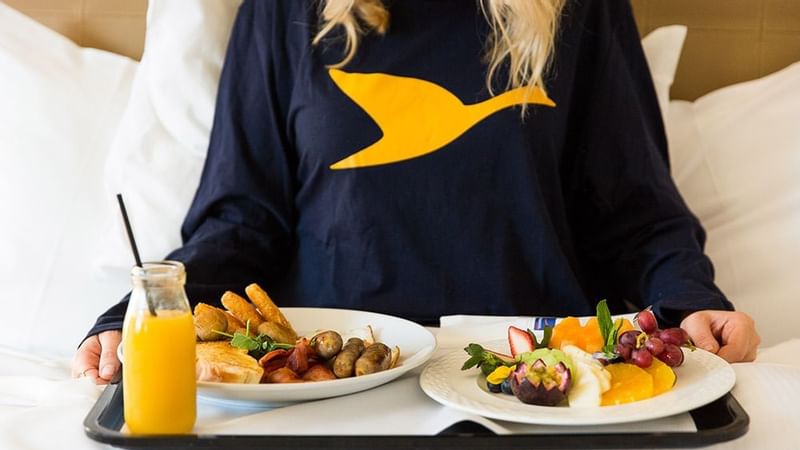A lady enjoying food in Novotel Darling Harbour