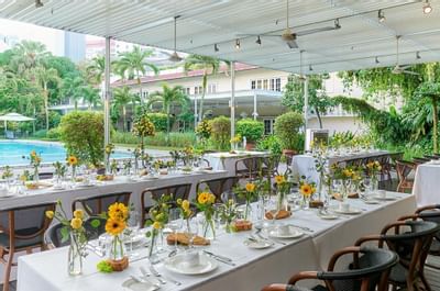 Table setup by the pool for an event at Goodwood Park Hotel