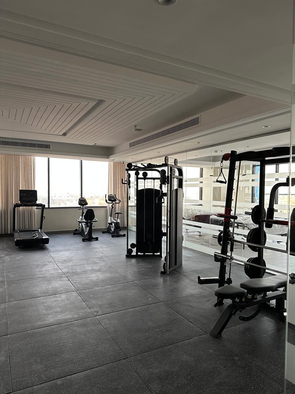 Fully equipped fitness center at Warwick Jeddah Hotel & Spa with city views and cardio