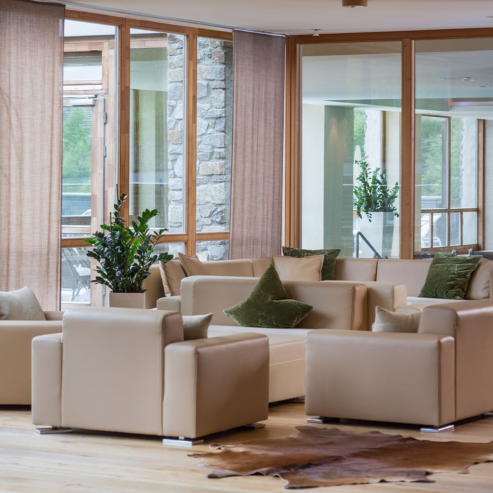 Lobby lounge area with plush seating at Falkensteiner Hotel Cristallo