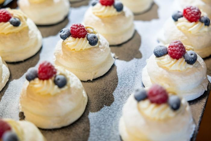 Mini desserts topped with fresh berries and cream served at Strahan Village