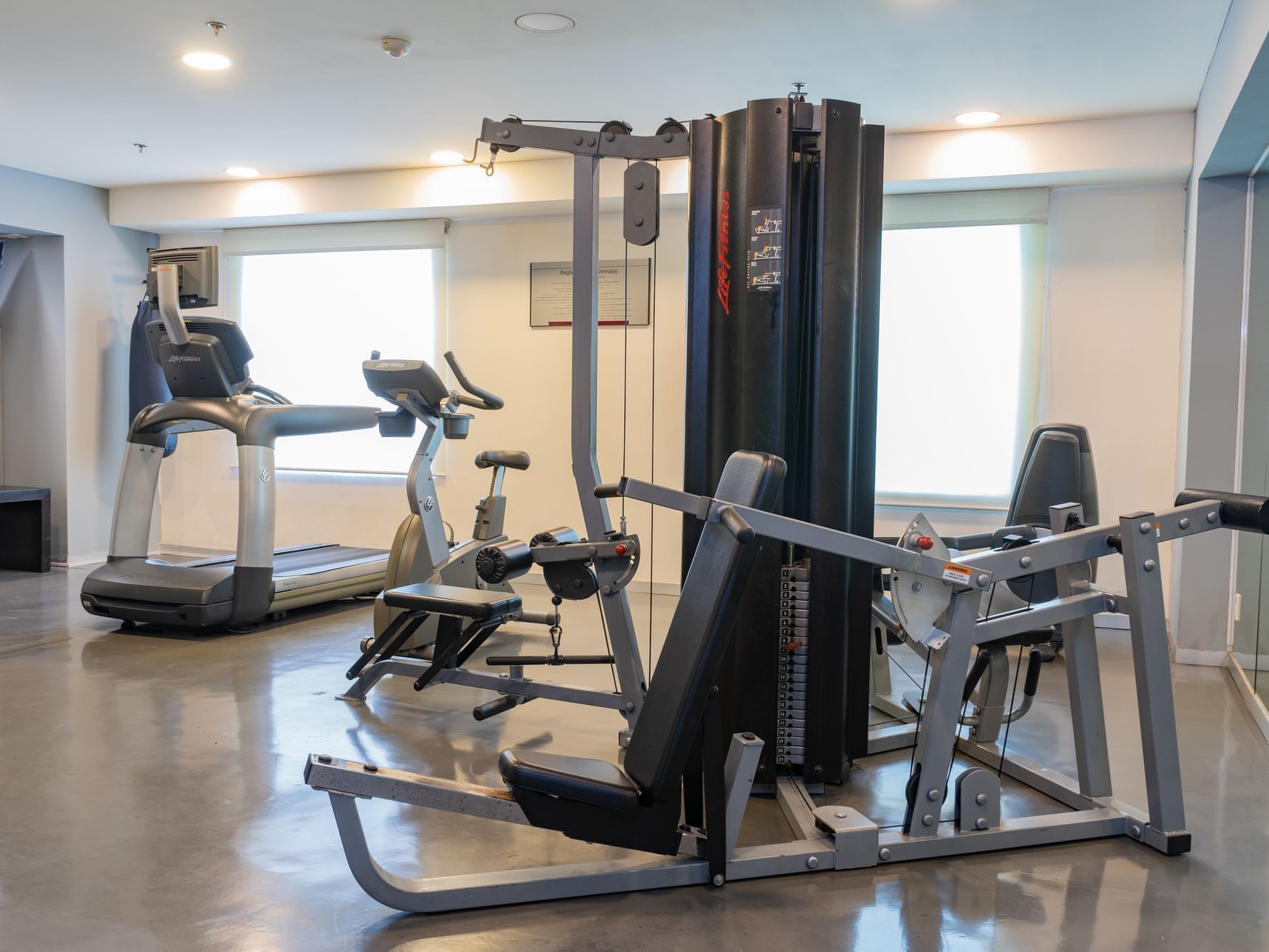 Gym with equipment and window with a view at Fiesta Inn