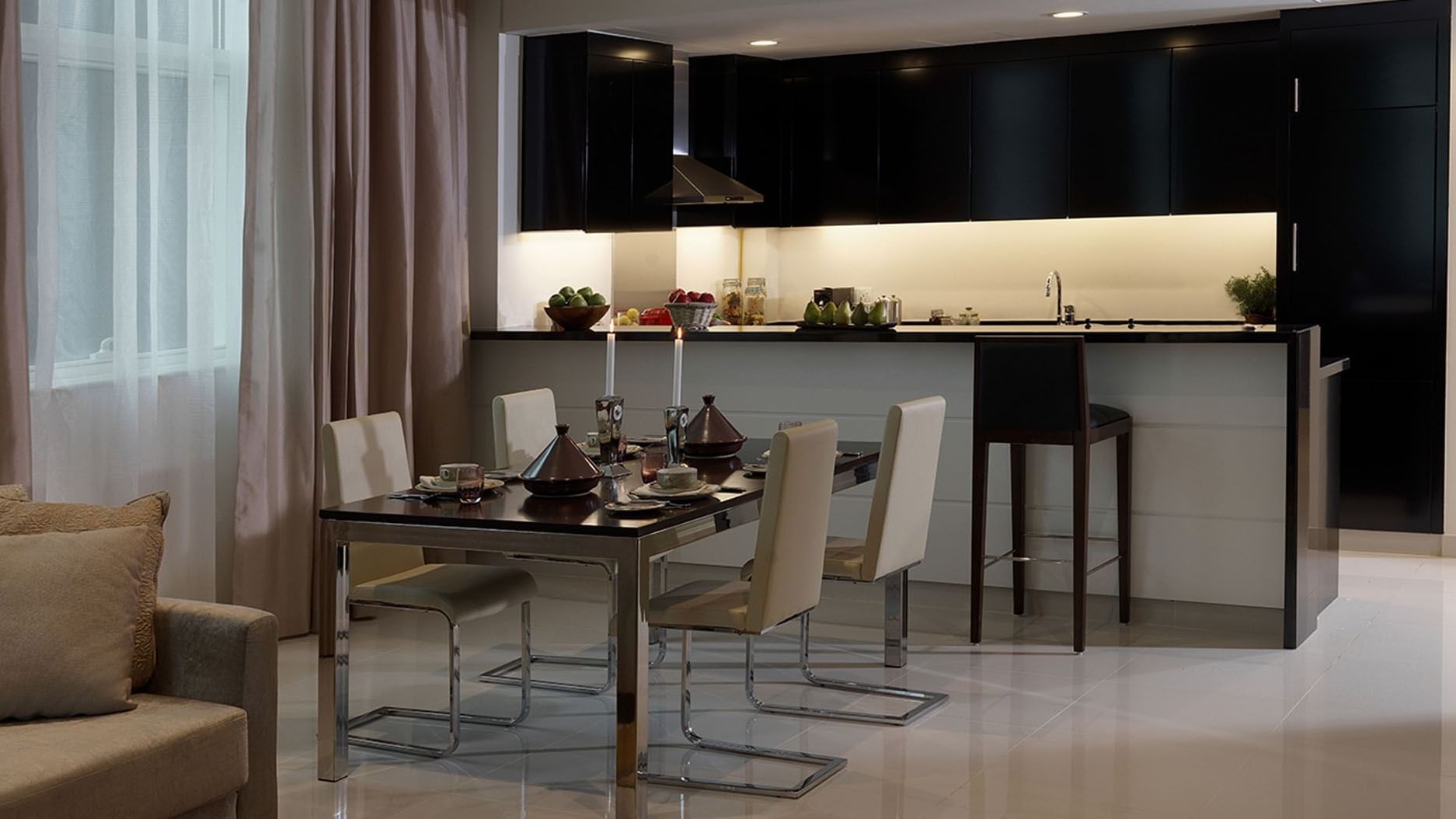 Kitchen & dining area featuring modern furniture in a Suite at DAMAC Maison Cour Jardin