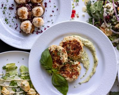 Crab cakes, scallops, and salads served in the restaurant at The Ashbrook Hotel, one of the best hotels in Kentucky