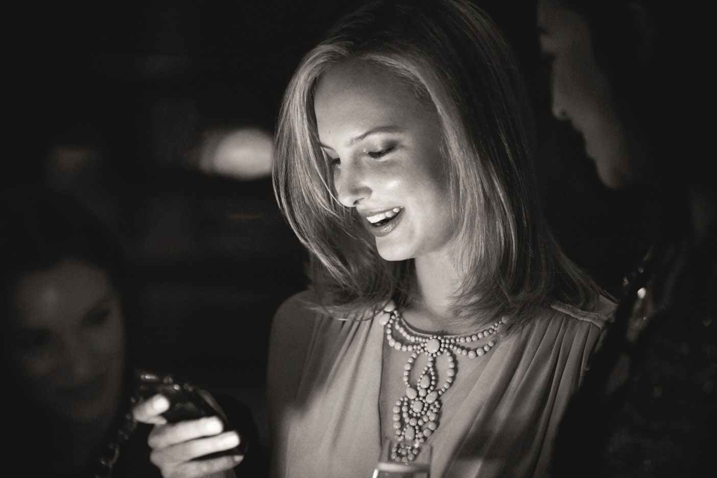 Black & white image of a women holding a phone at Crown Perth