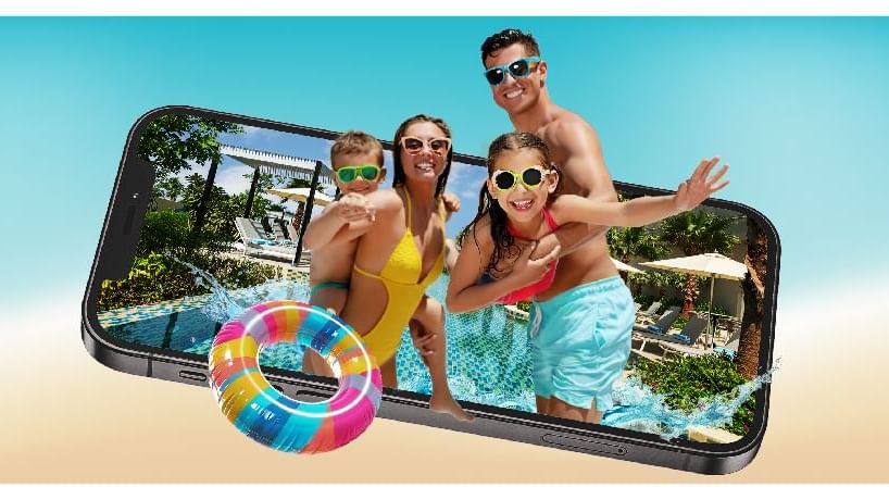 A smartphone showcasing a photo of a family by a pool at DAMAC Maison Aykon City