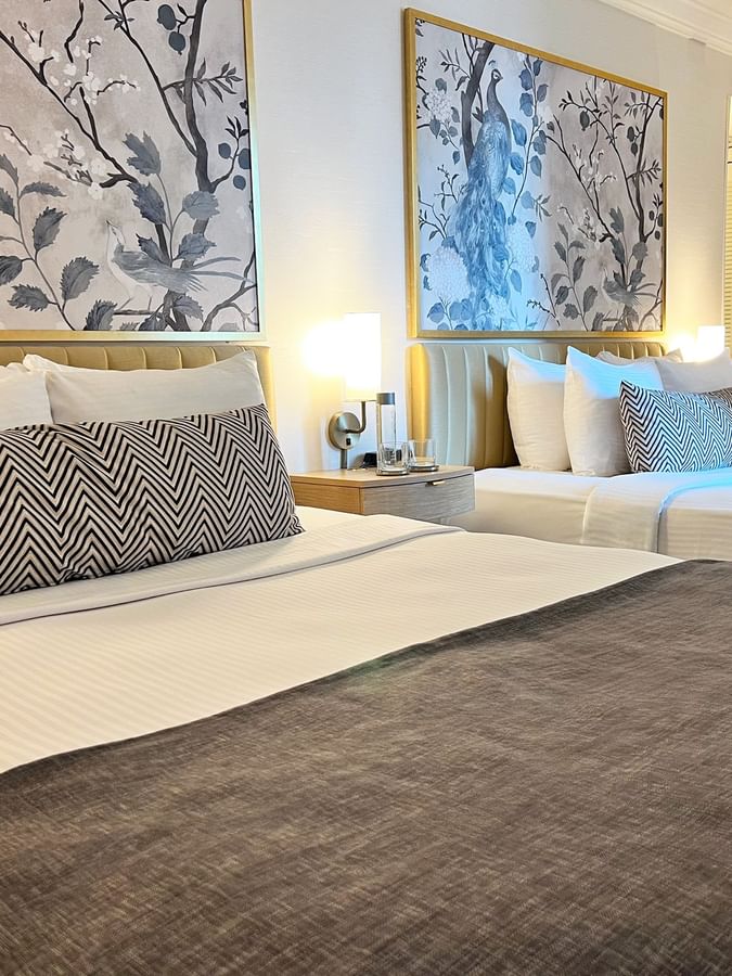 Executive Two Queen Beds room with artwork and television at Warwick Allerton Chicago