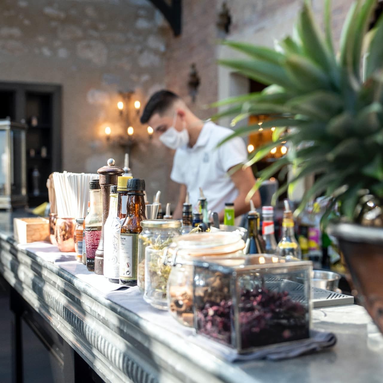 Bartender at the counter of The Bar at Domaine de Manville