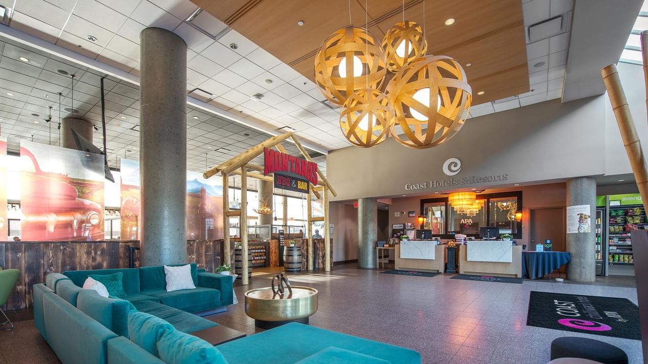 Lobby of Coast Chilliwack Hotel by APA with couches and circular table.