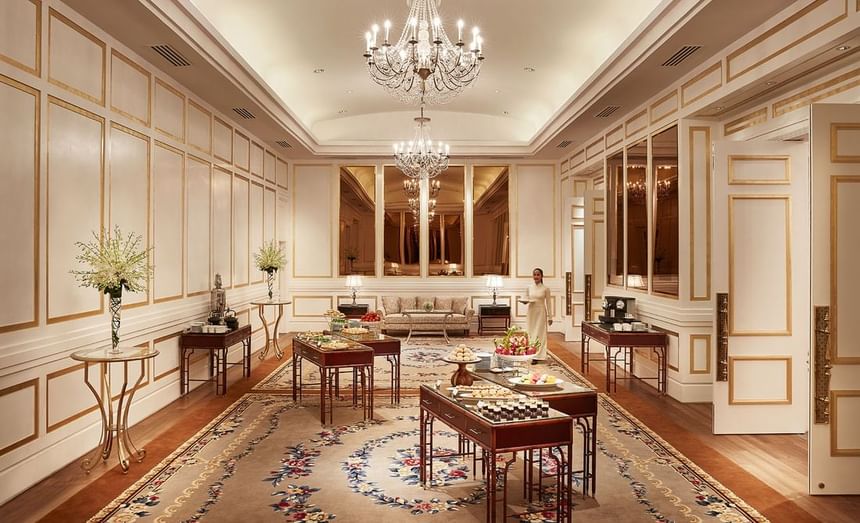 Refreshment tables arranged in the Ballroom Foyer with luxury furniture, carpeted floors & chandeliers at Park Hyatt Saigon