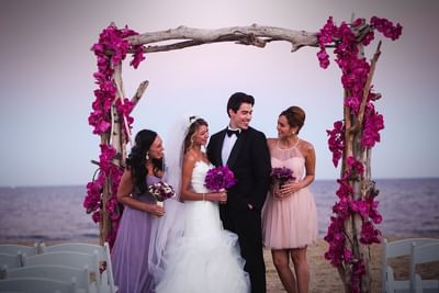 Groom and bride with bridesmaids by the beach at Ocean Place