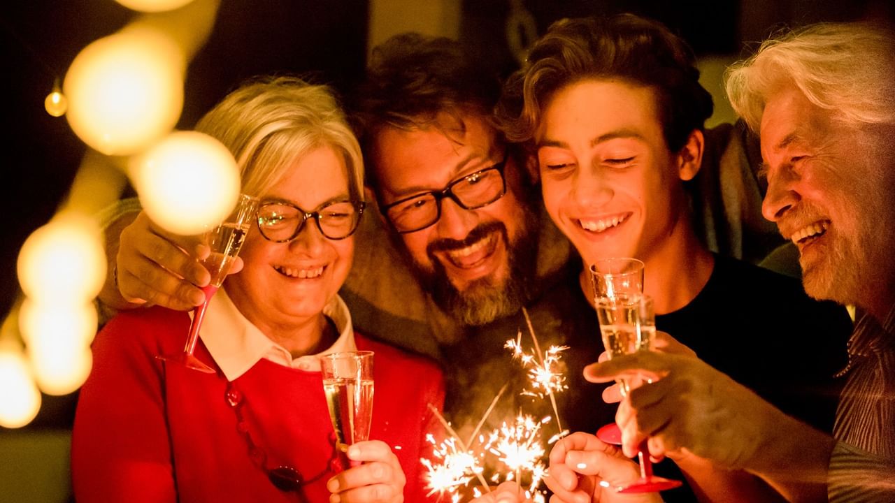 four people celebrating with sparkles