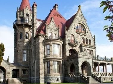 A stunning daytime shot of Craigdarroch Castle, a historic mansion and a short drive from Embassy Inn Victoria