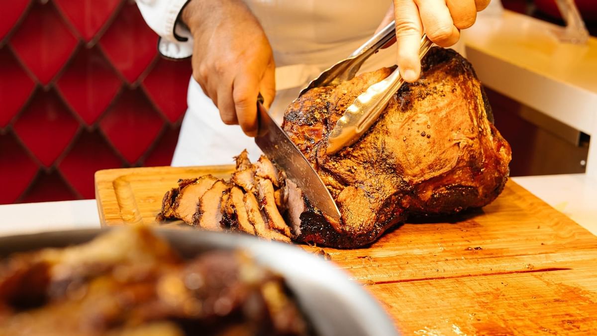 A Chef Cutting meat in Atrium restaurant at Crown Hotel Perth