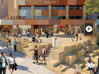 Exterior rendering of UniLodge Brisbane City showing pedestrians and building with retail stores.