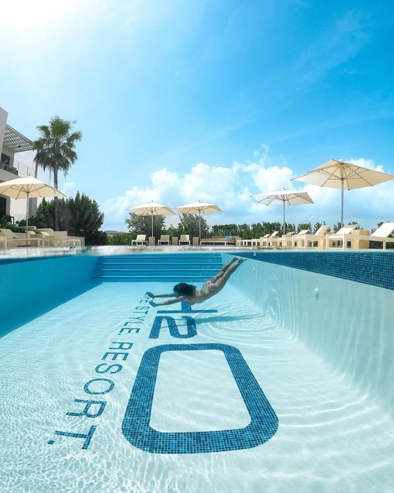 Woman diving in the main pool at H2O Life Style Resort