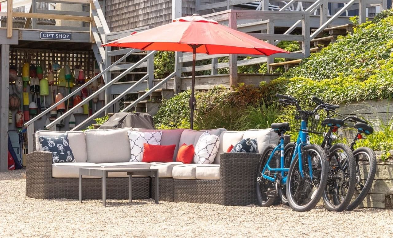 Bicycles parked by the patio with comfy sofas near the gift shop at Chatham Tides Resort