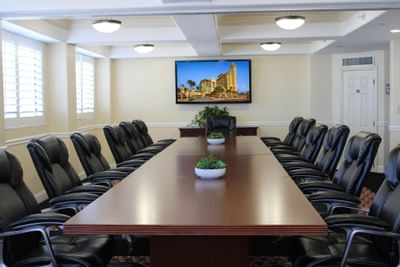boardroom with executive chairs and television on wall