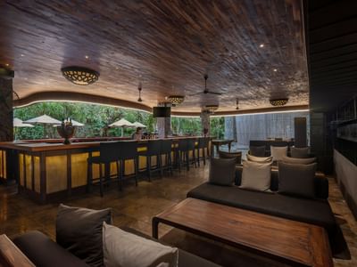 Elegant bar area with wooden ceiling and furniture at Peppers Seminyak