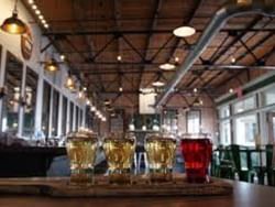 Four beers served on a counter top at Last Chance Pub & Cider Mill near Boothill Inn & Suites