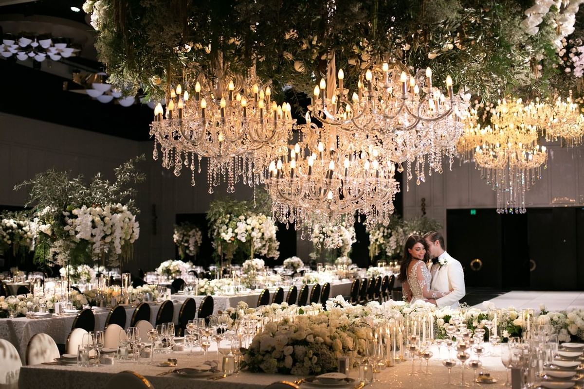 A wedded couple posing in a ballroom at Crown Hotel Perth