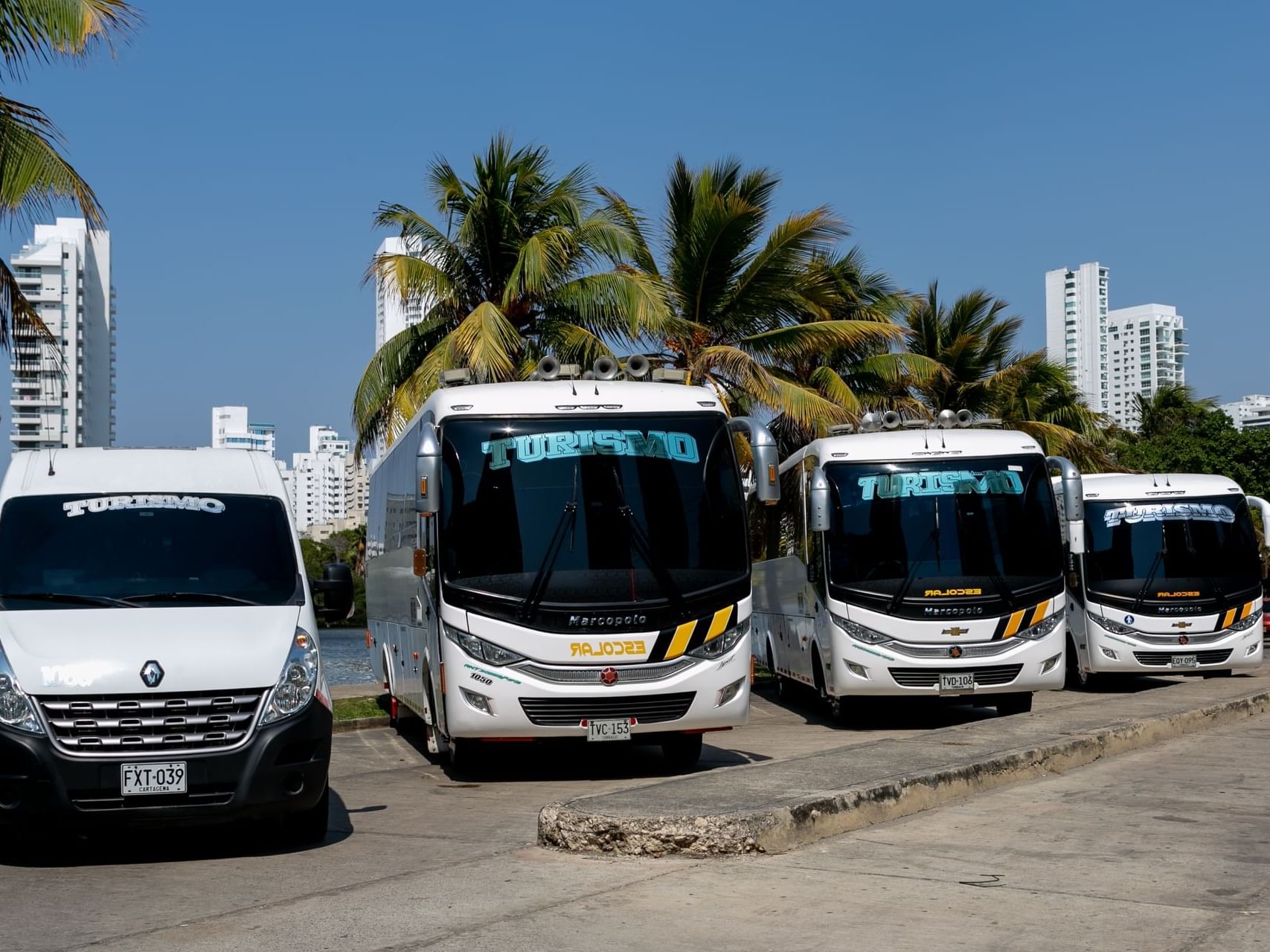 Several tour buses lined up in parking slot at Hotel Isla Del Encanto