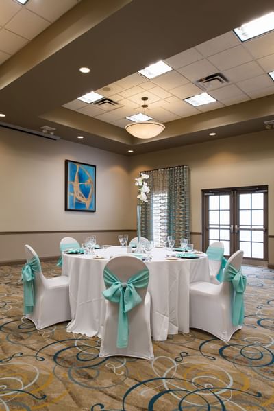 a circular table and chairs in a ballroom