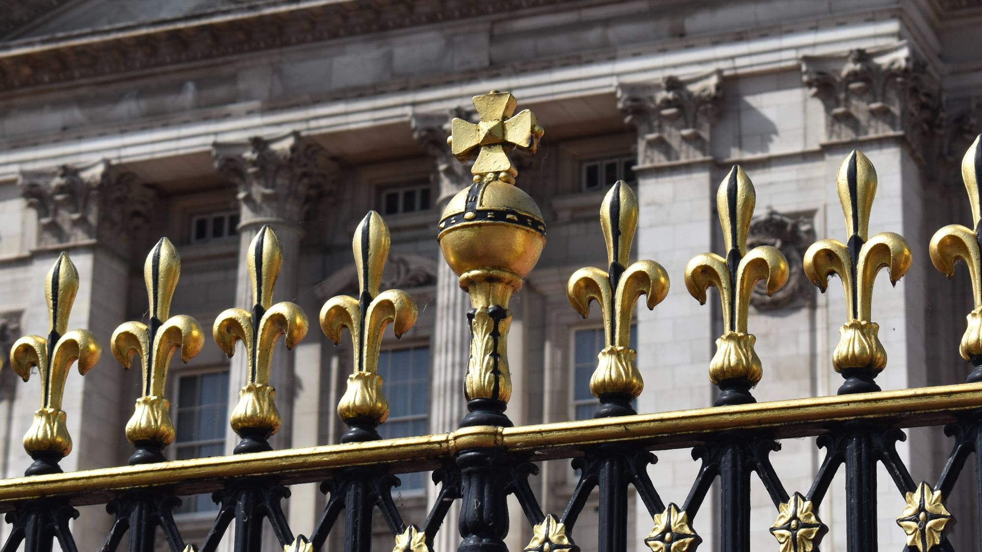 Close-up of an elegantly designed golden metal fence with bars at The Londoner