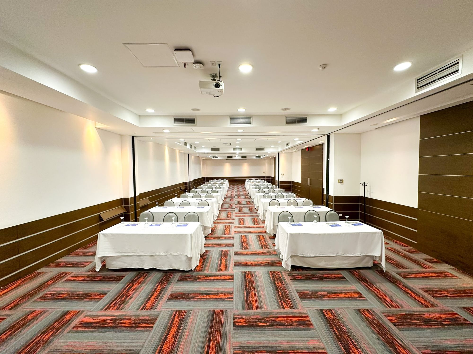 Seating arranged on the carpeted floor in Ceibas at San Fernando Plaza Hotel