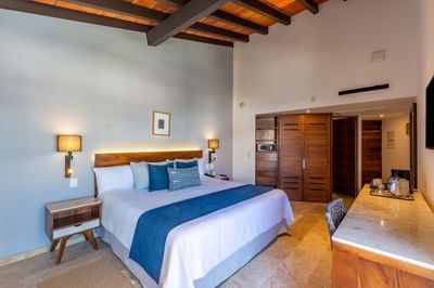 Deluxe King Bed Ocean View with comfy bed, closet and work desk at Buenaventura Grand Hotel and Spa